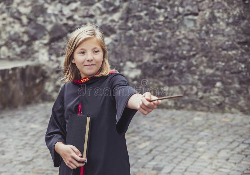 Young sorceress in the castle conjuring by magic wand. Young sorceress in the castle conjuring by magic wand.