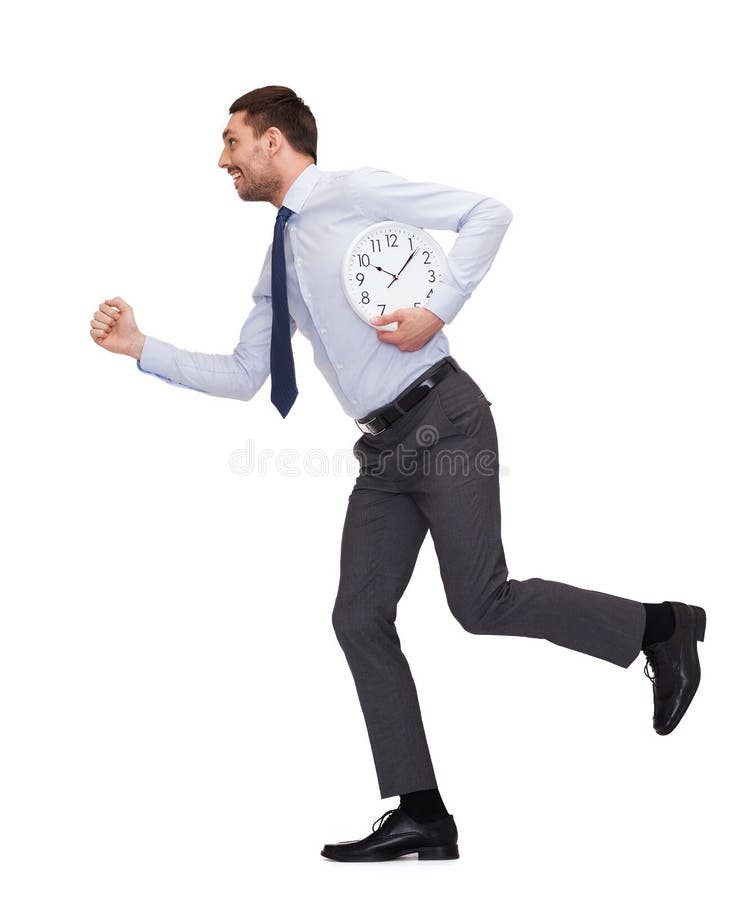 Giovane uomo d'affari sorridente con funzionamento dell'orologio immagini stock Giovane uomo d'affari sorridente con funzionamento dell'orologio immagini stock