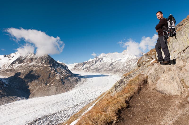 Tourist looking at Aletsch Glacier - largest European glacier, Bernese Alps, Switzerland. Tourist looking at Aletsch Glacier - largest European glacier, Bernese Alps, Switzerland