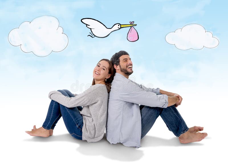 Young attractive Hispanic couple on floor, pregnant women sitting together handsome husband and flying stork bringing baby in pregnancy and family growth concept. Young attractive Hispanic couple on floor, pregnant women sitting together handsome husband and flying stork bringing baby in pregnancy and family growth concept