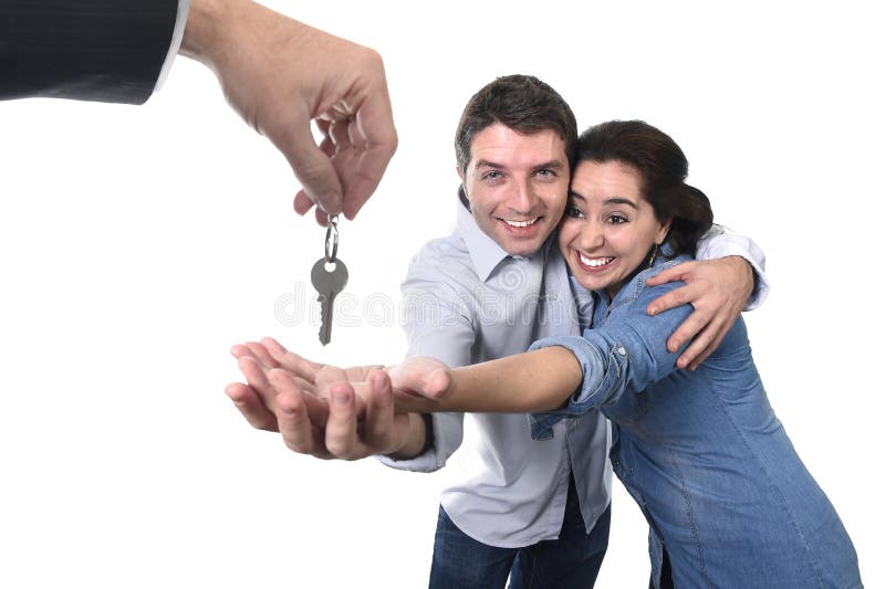 Giovani coppie felici che ricevono residenza chiave della casa la nuova nel concetto di stato reale fotografia stock Giovani coppie felici che ricevono residenza chiave della casa la nuova nel concetto di stato reale fotografia stock