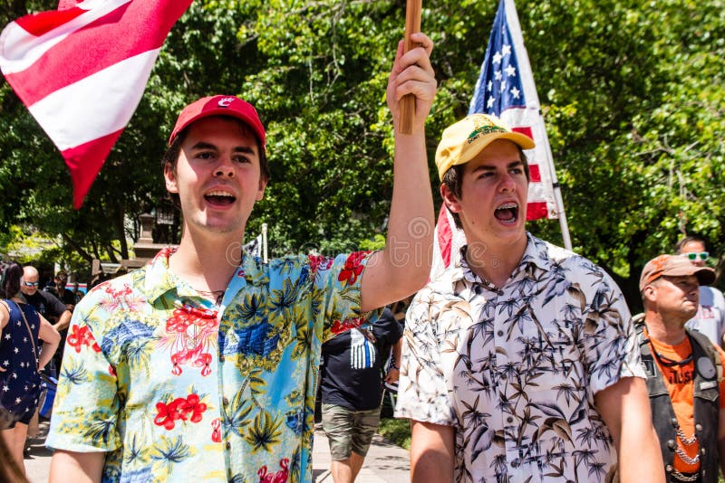 Two young men in Hawaiian shirts shout at a conservative rally. Hawaiian shirts are often worn by members of the far-right Boogaloo Boys.  Taken at a conservative rally supporting Donald Trump, and against mask mandates due to COVID-19. July 18th 2020. Downtown Columbus Ohio. Stand for America Rally. Two young men in Hawaiian shirts shout at a conservative rally. Hawaiian shirts are often worn by members of the far-right Boogaloo Boys.  Taken at a conservative rally supporting Donald Trump, and against mask mandates due to COVID-19. July 18th 2020. Downtown Columbus Ohio. Stand for America Rally.