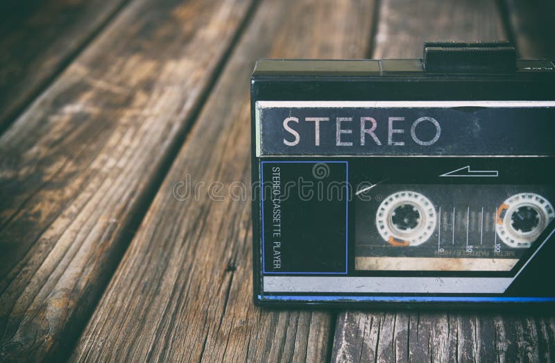 Old portable cassette player on a wooden background. image is instagram style filtered. Old portable cassette player on a wooden background. image is instagram style filtered.