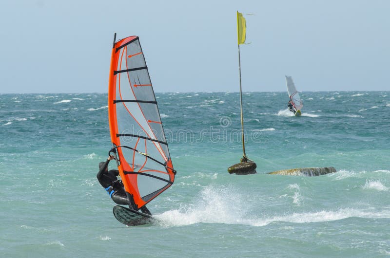 Extreme sportsman windsurfer rides on a Board sail on the Black sea near the coast of Anapa, Krasnodar region, Russia. Extreme sportsman windsurfer rides on a Board sail on the Black sea near the coast of Anapa, Krasnodar region, Russia