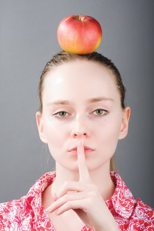 Girl with an apple stock photos