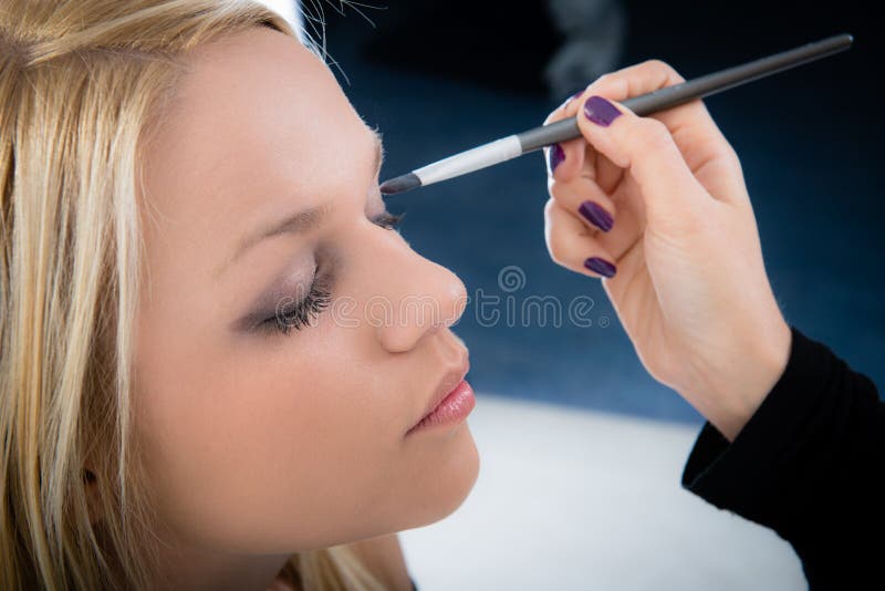 Girl applying make-up