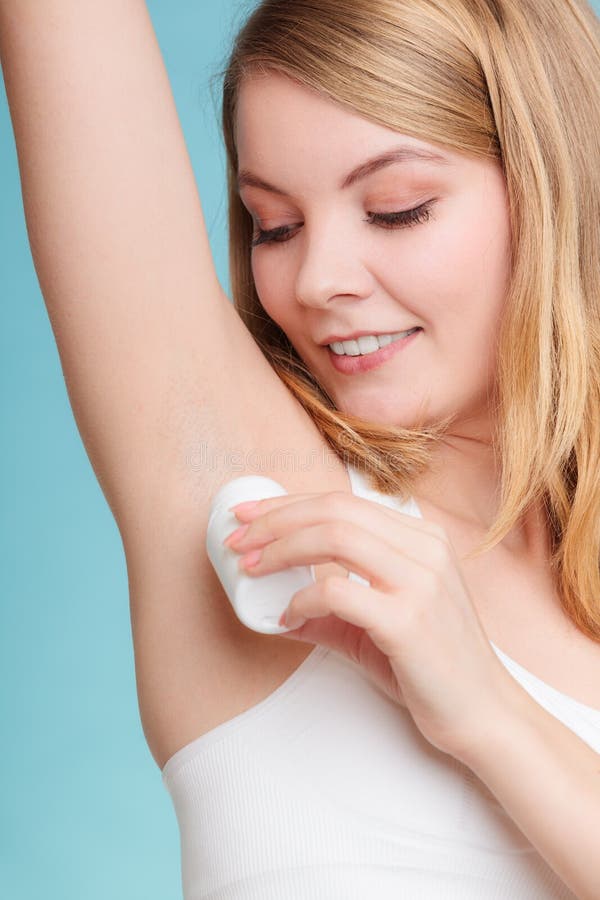 Daily Skin Care And Hygiene. Girl Wearing Bra Lingerie Applying Stick  Deodorant In Armpit. Woman Putting Antiperspirant In Underarms On Blue  Stock Photo, Picture and Royalty Free Image. Image 73504641.
