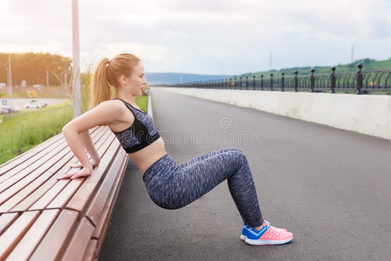 Girl Athlete Doing Sports Exercises Workout On The Waterfront Stock