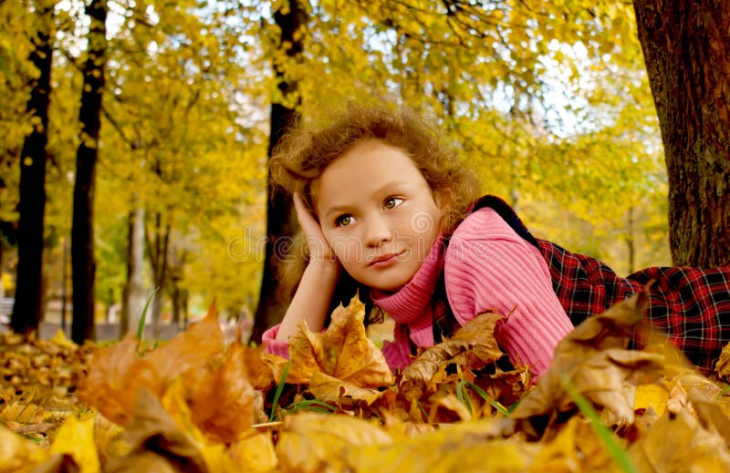 Girl in autumn leaves