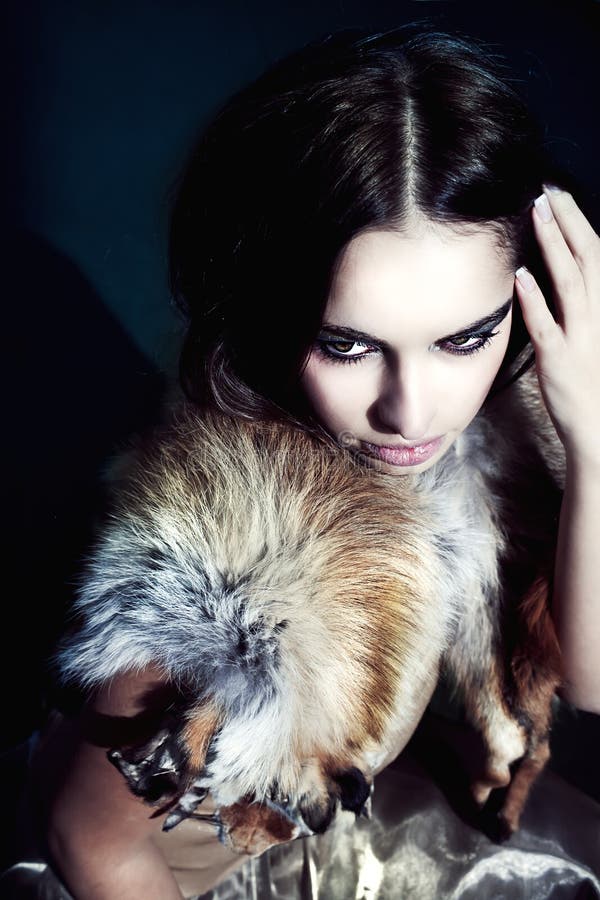 Girl with autumn makeup in furs