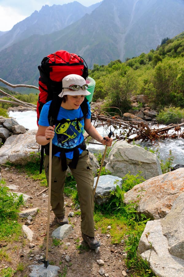Girl with a backpack along the river stock photo