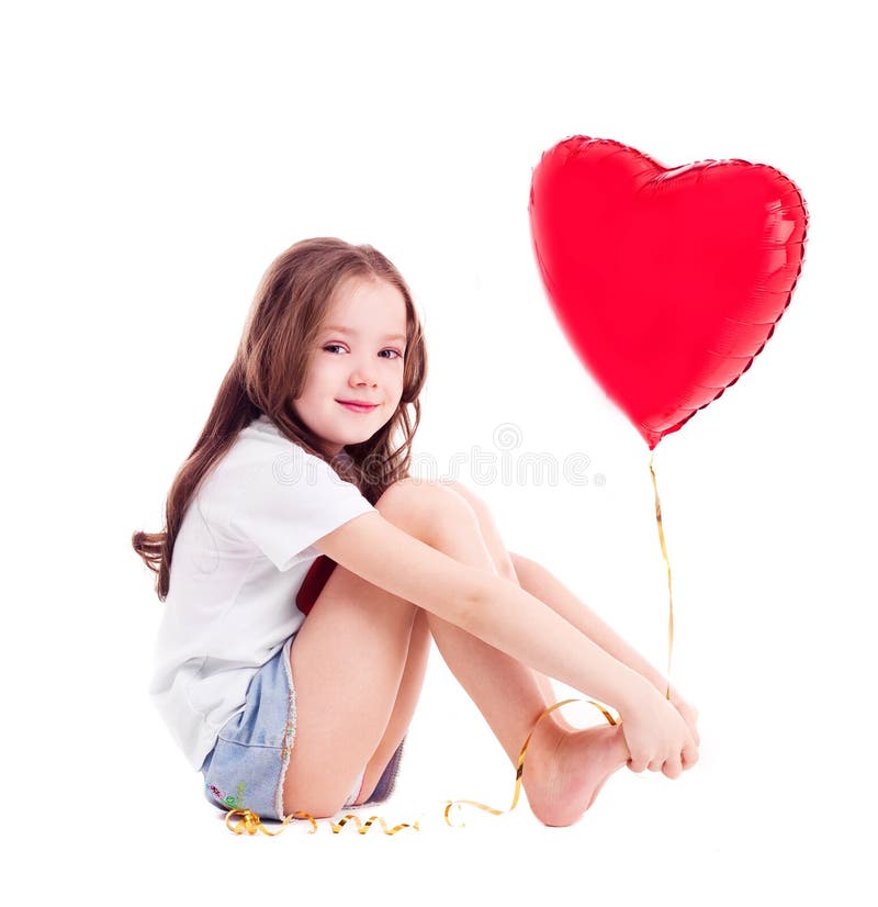 Cute six year old girl with a big red heart-shaped balloon, against white background. Cute six year old girl with a big red heart-shaped balloon, against white background