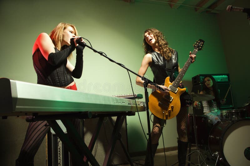 Caucasian girl band playing instruments. Caucasian girl band playing instruments.