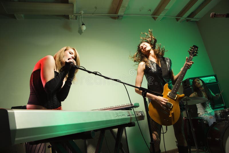 Caucasian girl band playing instruments. Caucasian girl band playing instruments.