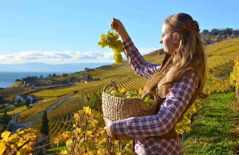 Girl with a basket full of grapes