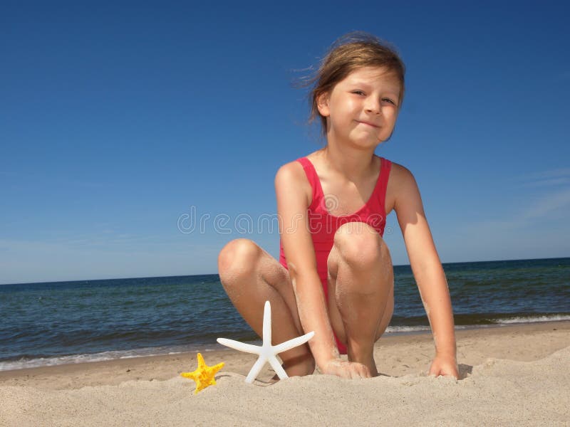 Girl on the beach with starfishes