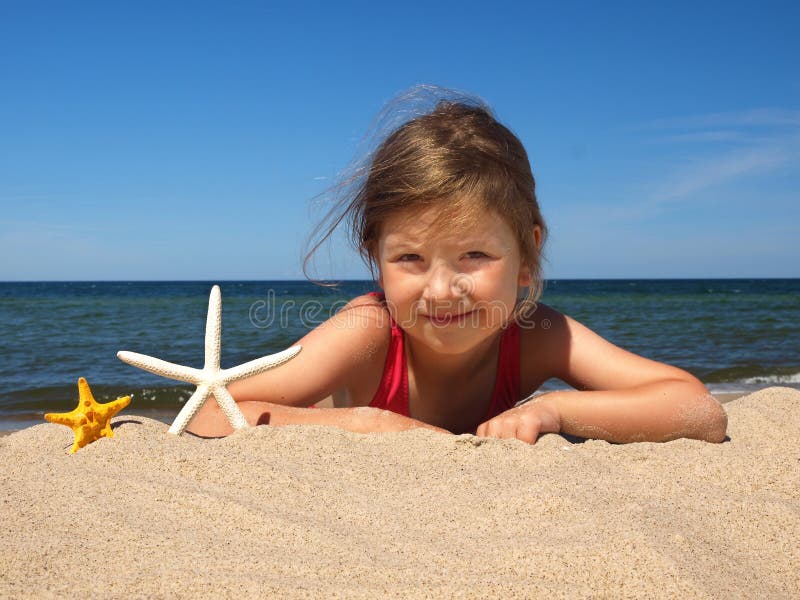 Girl on the beach with starfishes