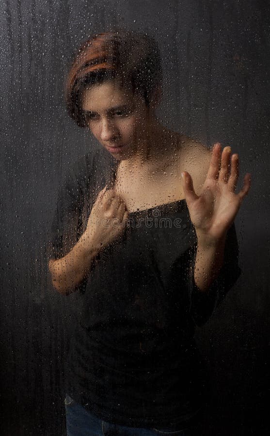 The girl behind the wet glass