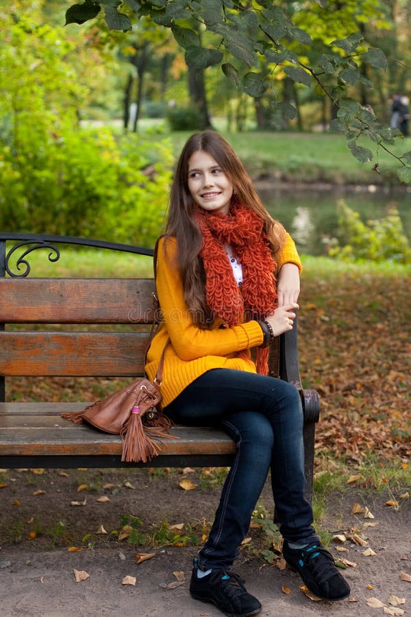 Girl on bench in autumn park