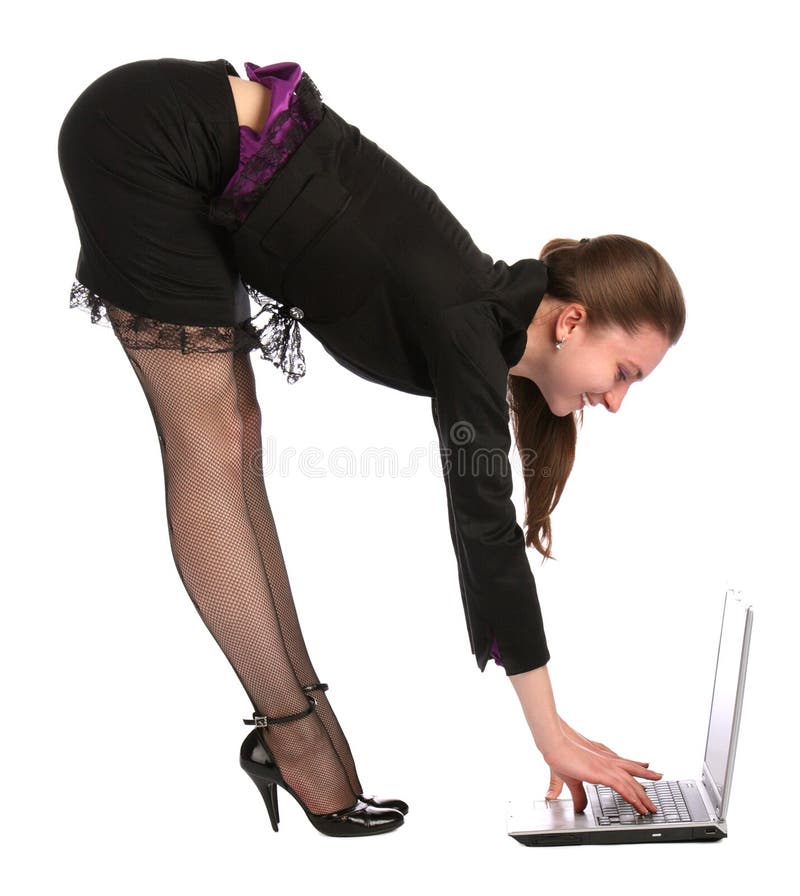 Girl bend forward to notebook on floor.