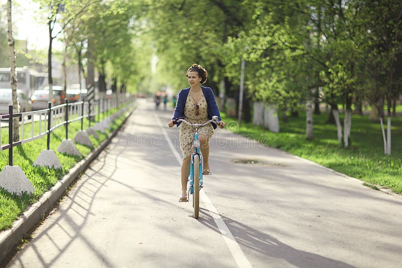 Girl on a bicycle in dress stock photo. Image of countryside 63504814