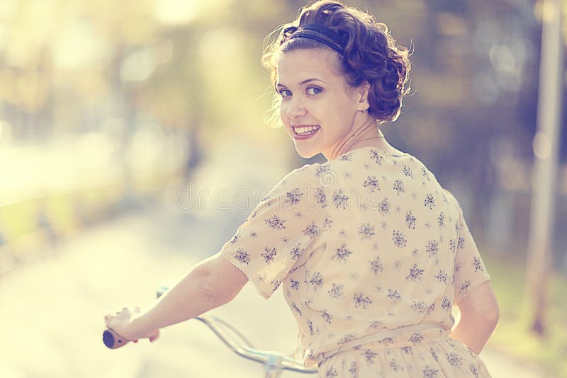 Girl on a bicycle in dress stock photo. Image of portrait 63504816