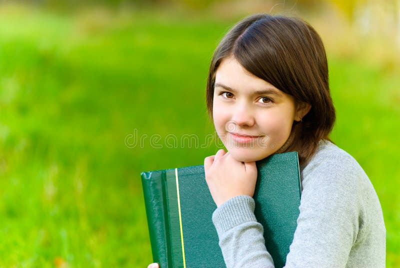 Girl with big book stock image. Image of park, cute, face 6975289