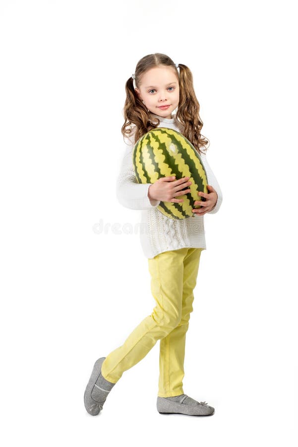 Girl with big toy watermelon on a white background. royalty free stock images Girl with big toy watermelon on a white background. royalty free stock images