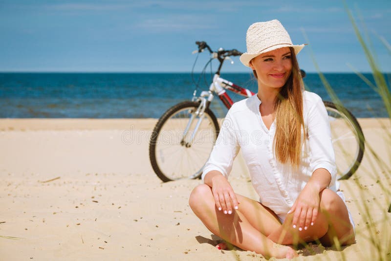 Girl with bike on beach.