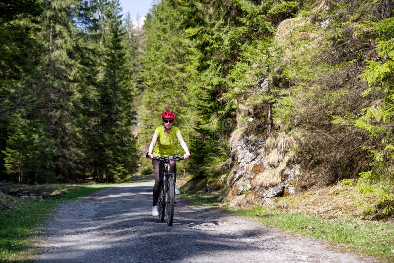 Girl on bike in forest at Ludrovska valley, Slovakia