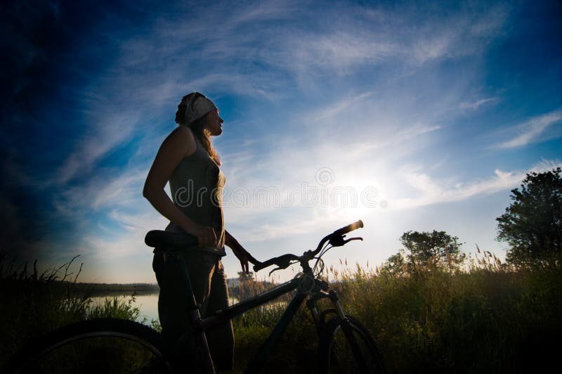 Girl biking at sunrise