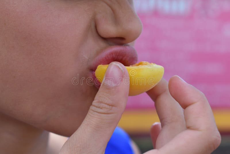 Girl bites fresh fruit close up stock photography Girl bites fresh fruit close up stock photography