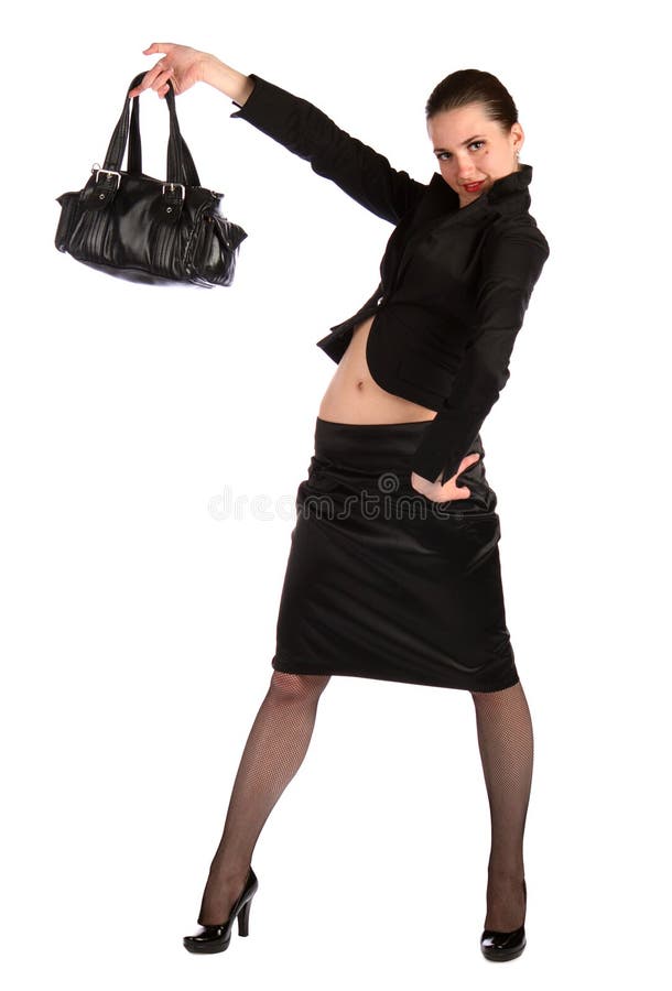 Girl in black suit holds bag.