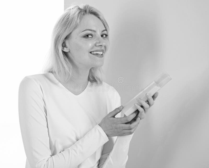 Girl blonde holds shampoo bottle. Expert tips achieve incredible hair. My hair care secret. Woman shows beauty product royalty free stock images Girl blonde holds shampoo bottle. Expert tips achieve incredible hair. My hair care secret. Woman shows beauty product royalty free stock images