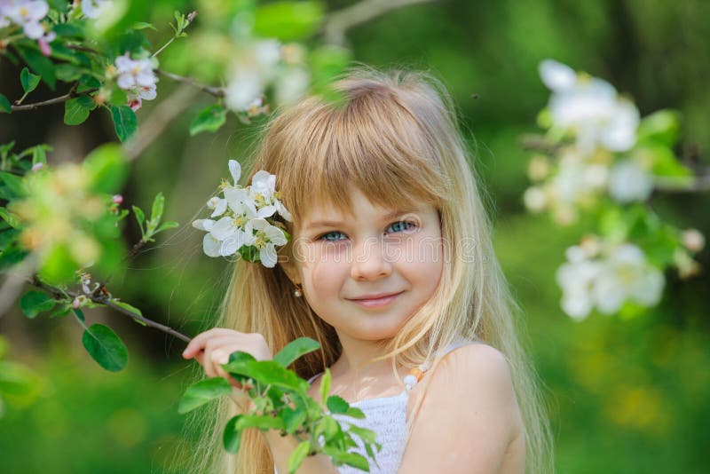 Girl in blooming apple tree garden