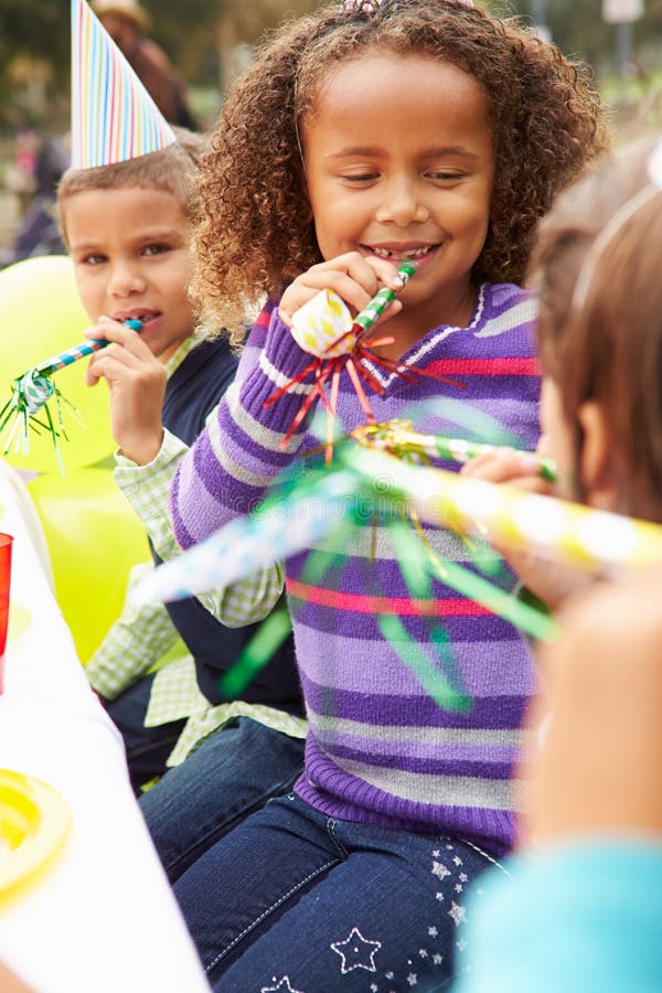 Girl With Blower At Outdoor Birthday Party