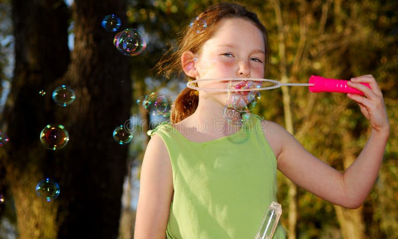 Girl Blowing Bubbles in Late Afternoon