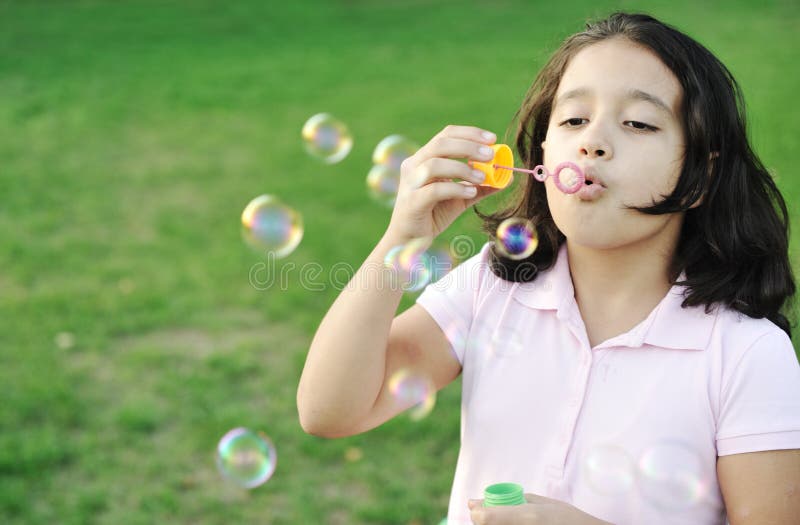 Girl blowing bubbles outdoor