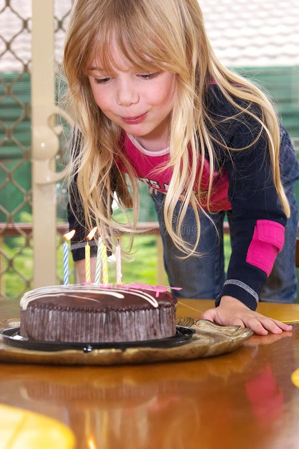 Girl blowing candles stock image Girl blowing candles stock image