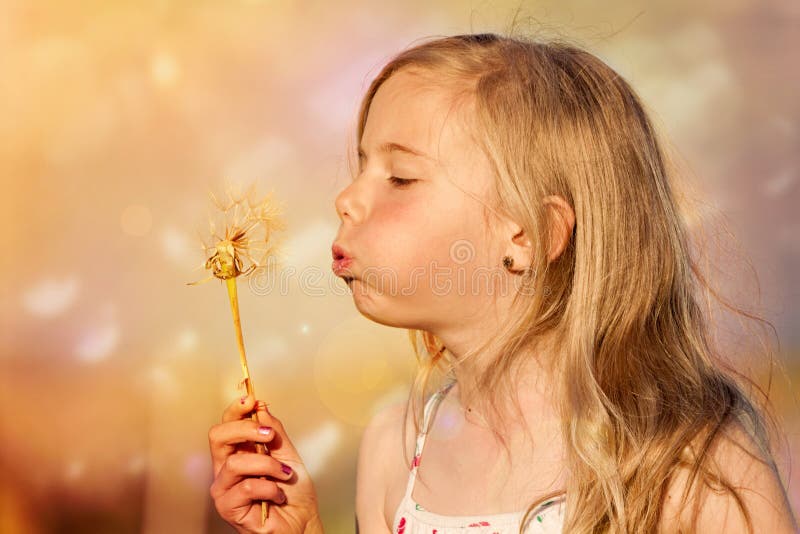 Girl blowing dandelion