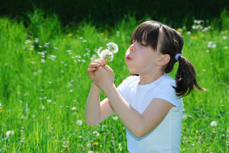 Girl Blowing Dandelion Seeds