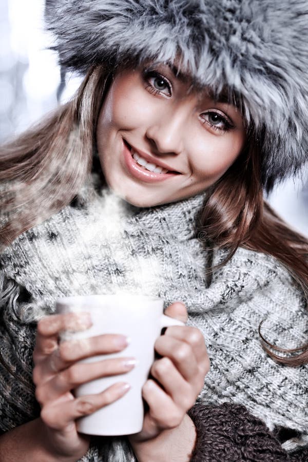 Girl blowing on hot drink