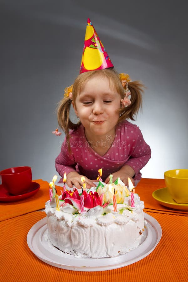 Girl blowing out candles royalty free stock photography Girl blowing out candles royalty free stock photography