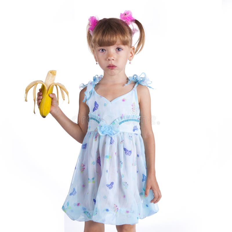 A girl in a blue dress with a banana
