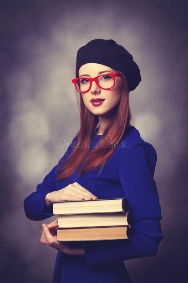 Girl in blue dress with books