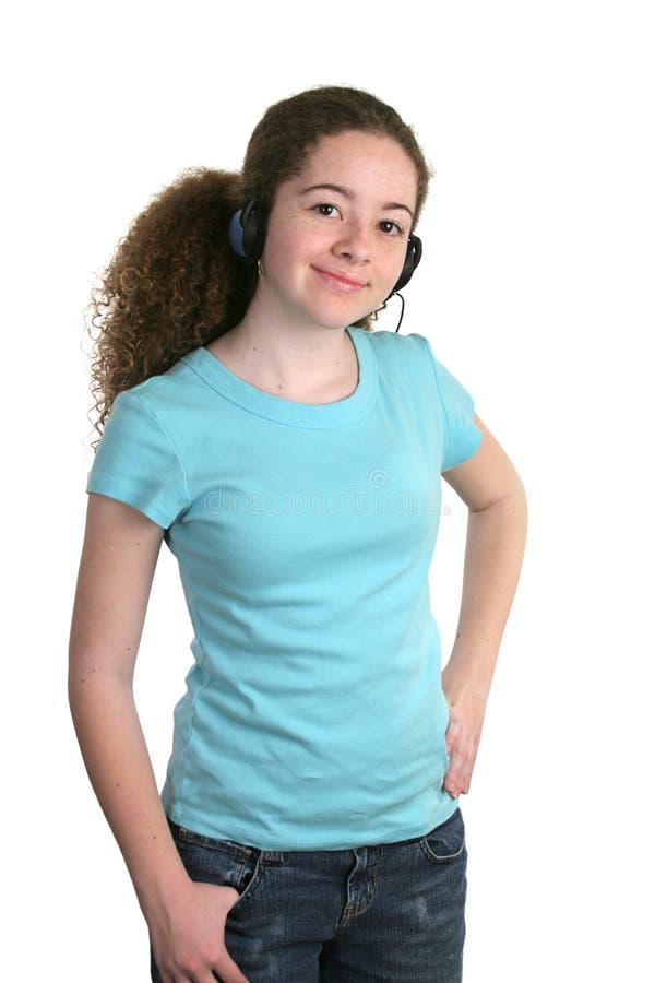 A smiling teen girl in a blank blue t-shirt and listening to headphones. Tee shirt ready for logo. A smiling teen girl in a blank blue t-shirt and listening to headphones. Tee shirt ready for logo.