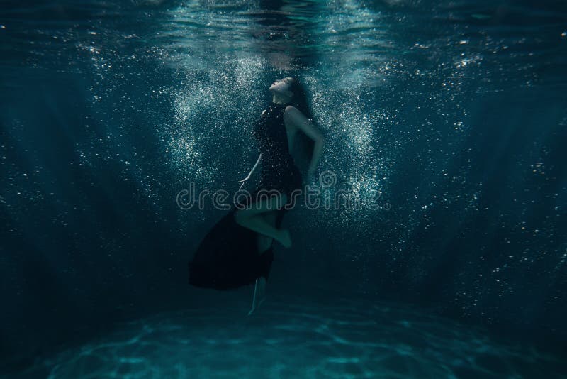 Girl at the bottom among rays. stock image