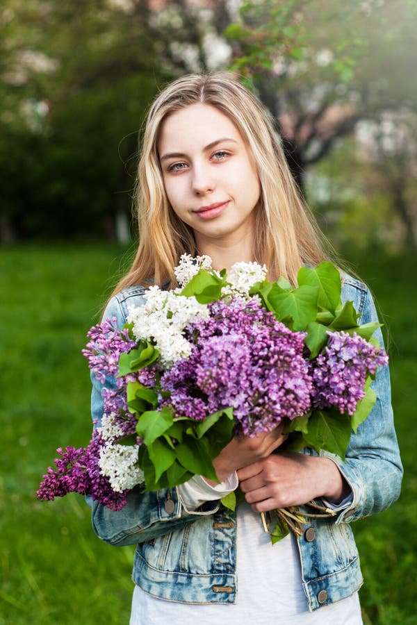 Girl with a bouquet of lilacs stock photos Girl with a bouquet of lilacs stock photos