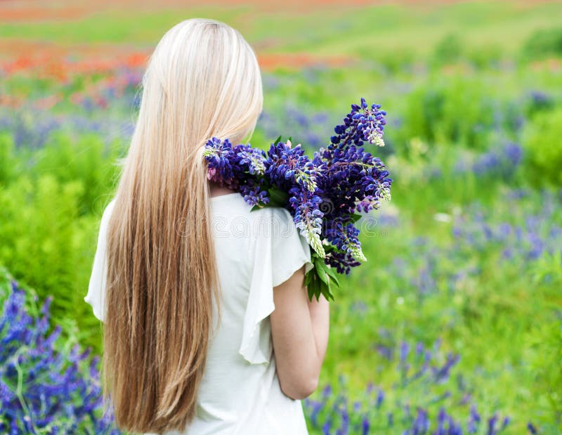 Girl with bouquet of lupine flowers stock photography Girl with bouquet of lupine flowers stock photography