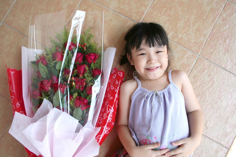 Girl & bouquet of roses lying on the floor